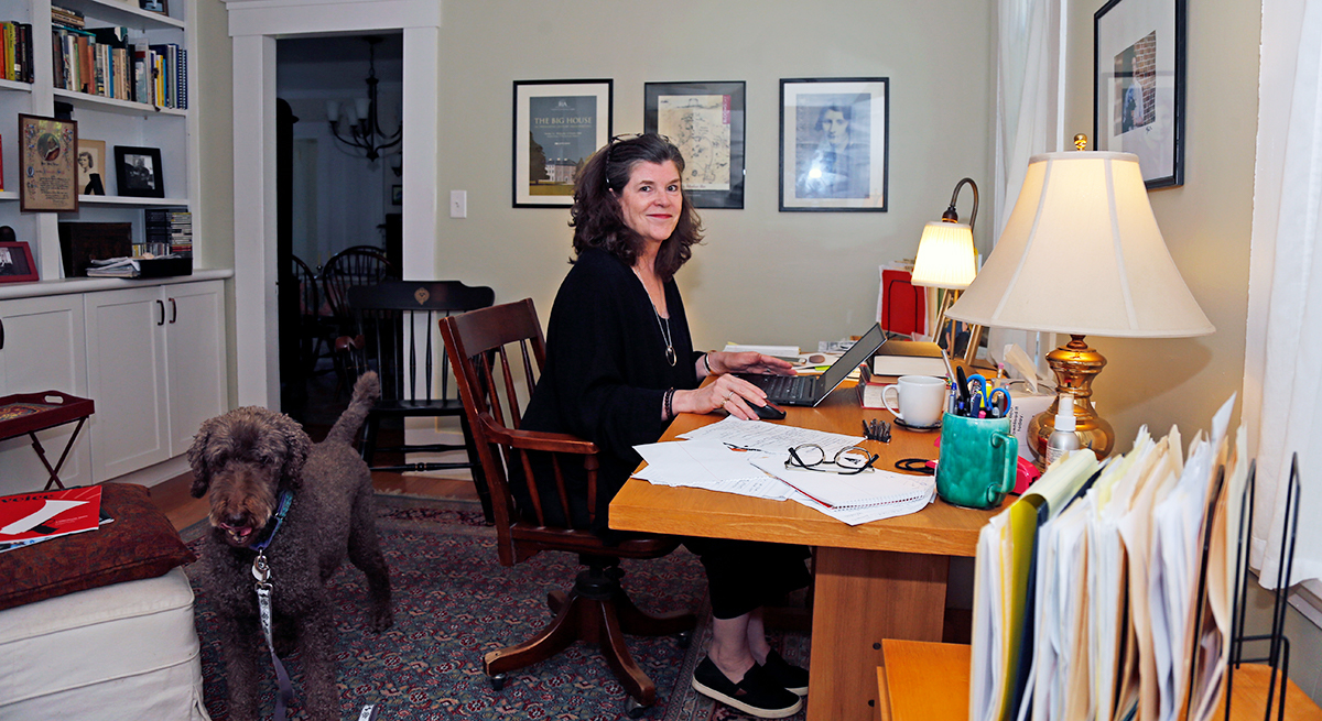 Ellen Wolff seated at her desk
