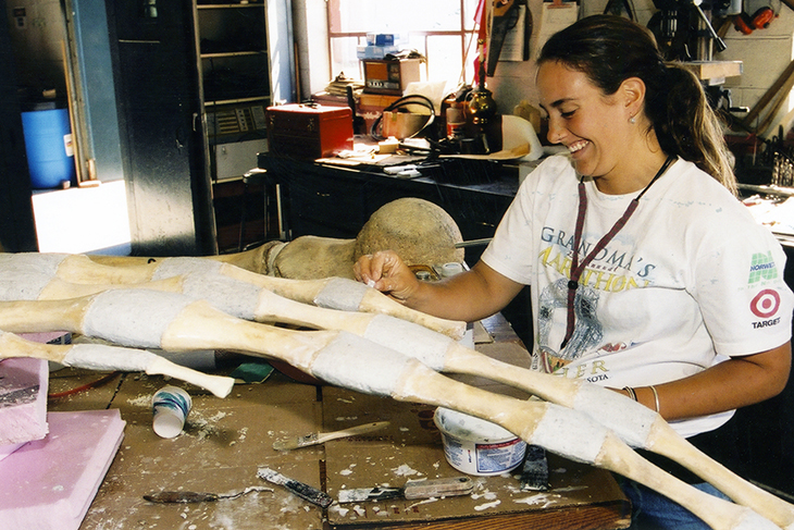 A woman works to clean the whale's skeleton 