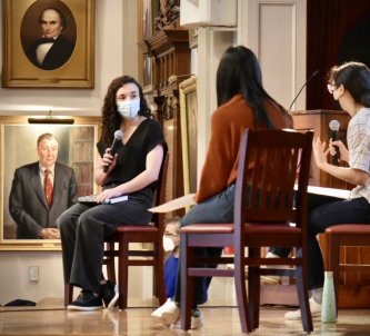 Devi Lockwood '10 (left) sits for an interview with Emma Chen '22 (center) and Lina Huang '22 during assembly Friday, Dec. 17, 2021.