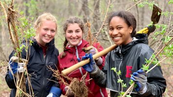 Addison Luce '21, Rachel Saltman '21 and Marymegan Wright '21 show off the fruits of their labor culling invasives from Southeast Land Trust property in Exeter.