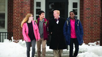Principal Rawson walks with students on the path