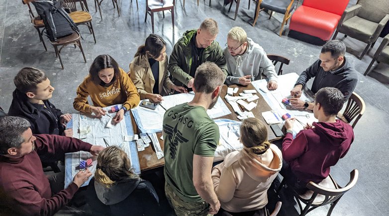 A group of people working together around a table.