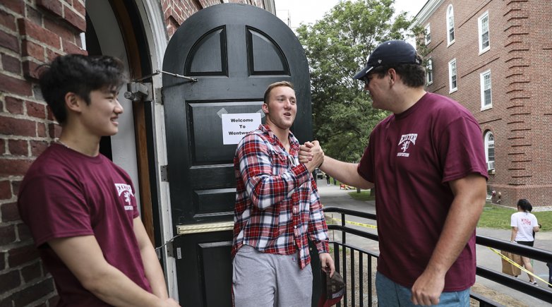 Exeter students greet each other outside of Wentworth Hall