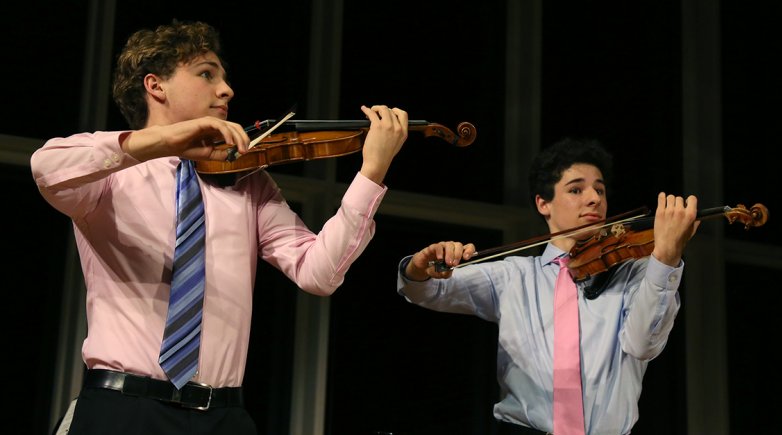 Dacha (left) and Sava Thurber have been playing violin since the age of 3.