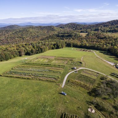 an open plain surrounded by trees and mountains of Vermont